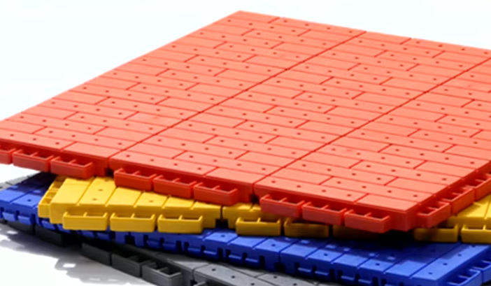 Stack of orange, yellow, blue and gray interlocking court tiles